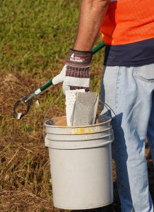 photo of person carrying bucket with trash